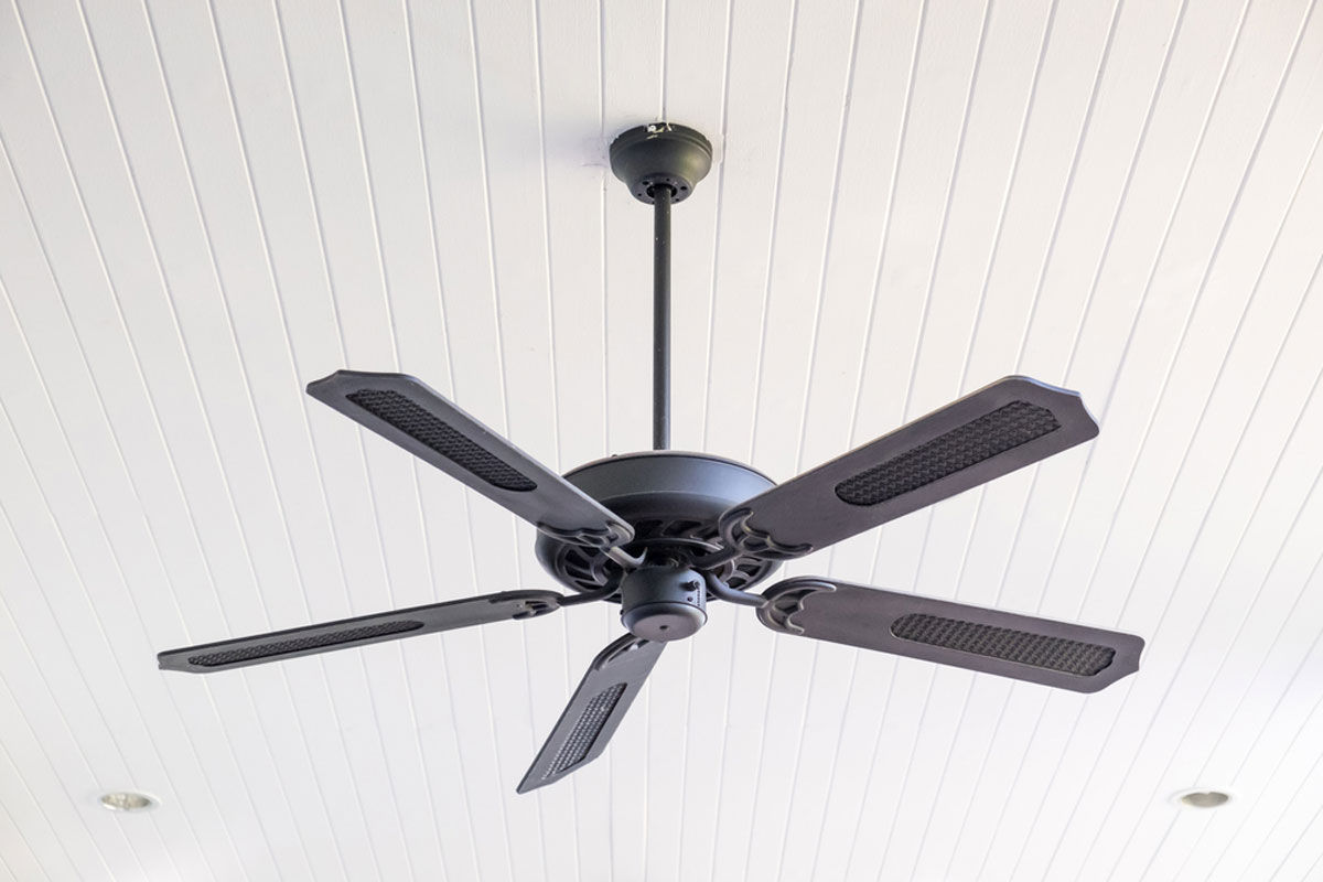 A ceiling fan in a room with white walls